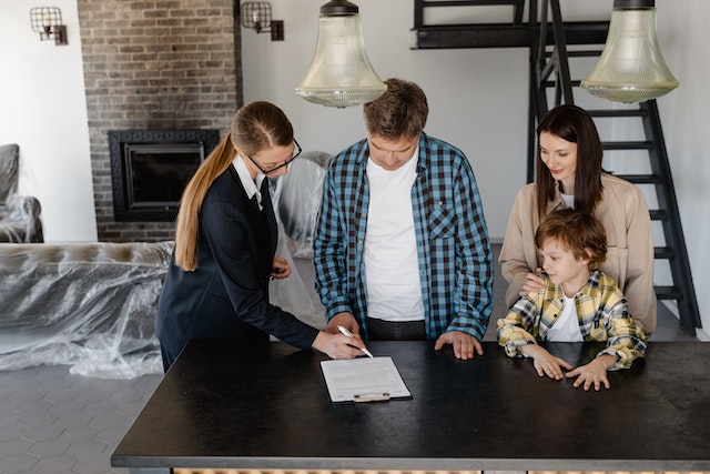 family signing paperwork in rental property